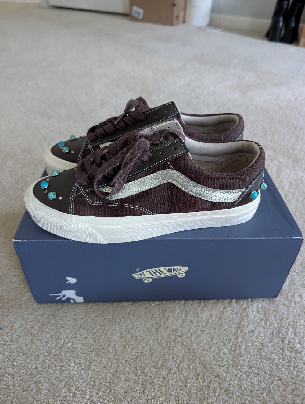 Vans Kids Low-Top Sneakers in Brown with Silver and Turquoise Accents.